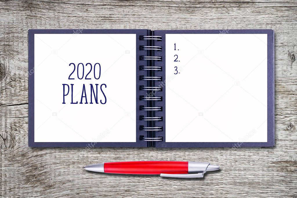 2020. Plans. Concept of ideas and goals for the new year. Notebook with a fountain pen on a wooden table. Copy space. Business.