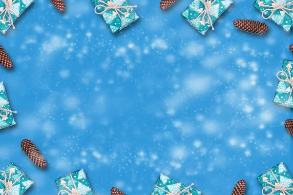 New Years gifts and cones on a blue background. . Copy space. Place for text. New Year. Christmas background.