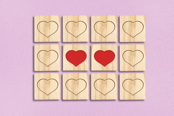 Hearts on wooden blocks on a pink background. Valentines Day, Mothers Day, Wedding background. — Stock Photo, Image