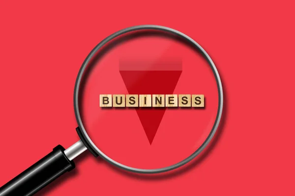 Business. Small inscription on wooden blocks on a red background. View through a magnifying glass. The fall of business. Business. — Stock Photo, Image