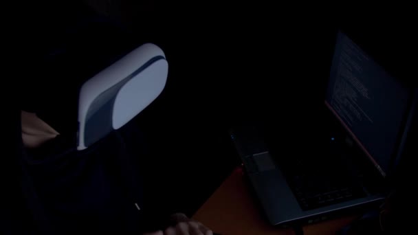Hacker em óculos VR quebrando código usando computadores na sala escura — Vídeo de Stock