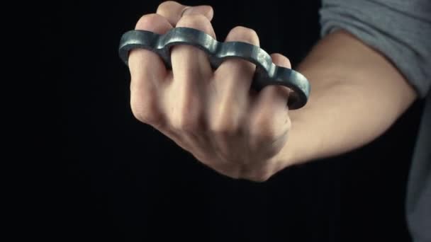 Placing knuckle-duster on the hand male fist with brass knuckles — Stock Video