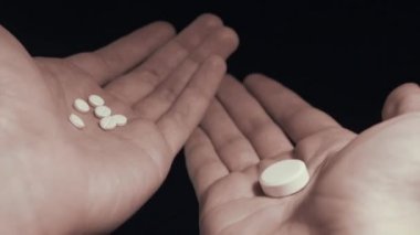 Birkaç küçük hap ve elindeki bir büyük hap arasında seçme adam hepsini al