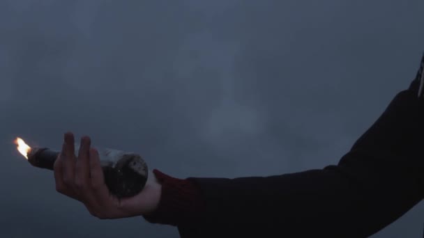 Close up of young protester hand with a burning Molotov cocktail — Stock Video