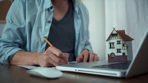 Male hands making note with pencil at printed graphs and uses wireless mouse — Stock Video