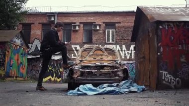 Smartphone ayakta çöktü yandı car yakınındaki kullanan genç adam. Kentsel yaşam tarzı
