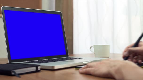 Hands of young designer using a tablet and a laptop computer at home — Stock Video