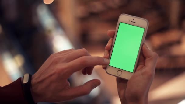 Manos masculinas usando teléfono con pantalla verde en el centro comercial — Vídeos de Stock