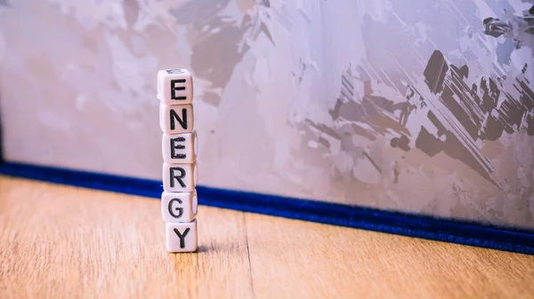 ENERGY cube letter in pile with solar silicon cell surface in background. Concept of renewable clean energy — Stock Photo, Image