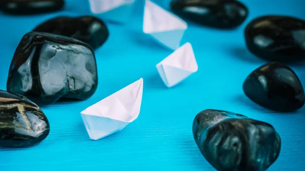 Leadership lead further white paper ships between stones on blue background
