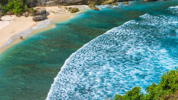 Paar am schönen atuh-strand mit weißen langen wellen, nusa penida, bali, indonesien — Stockfoto