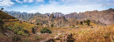 Gorgeous panorama view of the fields of intensive terrace cultivation surrounded by the huge barren mountain peaks, walls and cliffs. Santo Antao Island, Cape Verde clipart