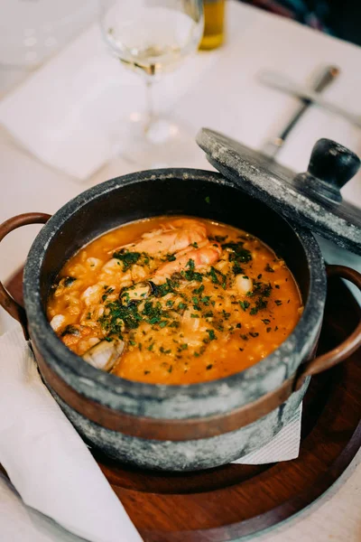 Cape Verde Ulusal mutfağı: geleneksel taş kase Cachupa. Yanında döşeme taş kapak.