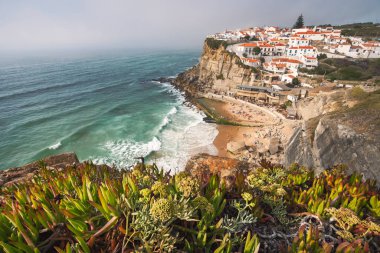 Sintra, Lisbon, Portugal. Azenhas do Mar white village landmark on the cliff and Atlantic ocean waves clipart