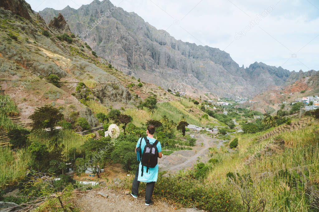 Santo Antao Cape Verde. Hiker with backpack going down the valley. Rocky terrain of high mountain ranges and deep ravines around