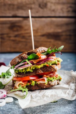 Guacamole, domates, roka ve pastırma sandviç