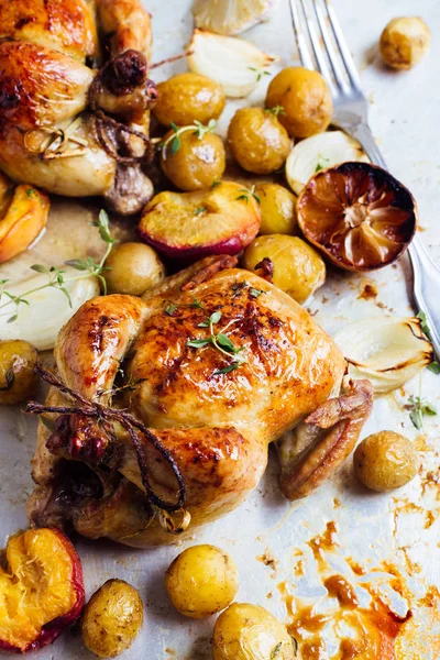 Two roasted chicken with potatoes. top view