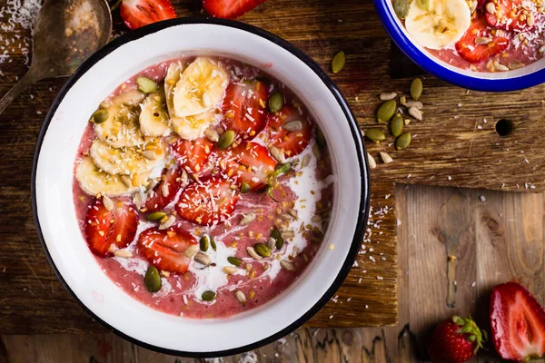Breakfast smoothie bowl. Strawberry, banana and coconut milk. Top view.