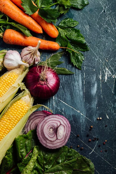 Malzemeler için lezzetli vejetaryen yemekleri pişirme sebze. Havuç, sarımsak, soğan, Mısır ve otlar. 