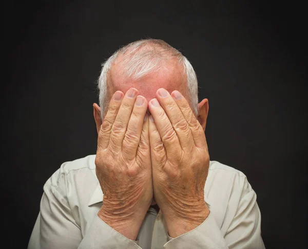 Portrait of an elderly man with face closed by hands — Stock Photo, Image