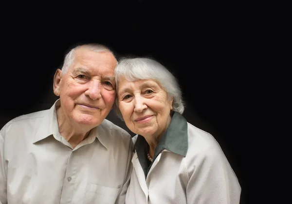 O casal de idosos em fundo preto — Fotografia de Stock