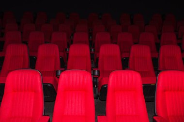 The empty movie theater with red seats clipart