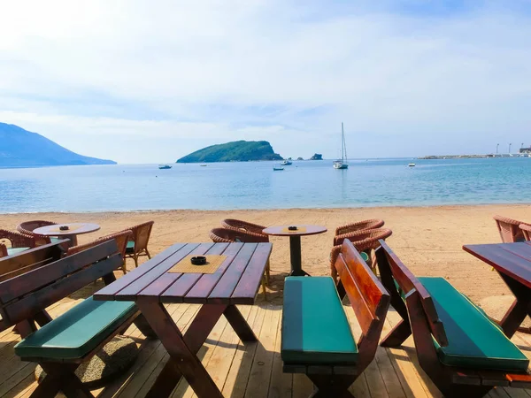 The empty tables on sea beach restaurant of Budva
