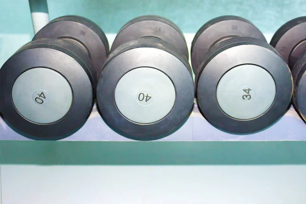 Sports dumbbells in modern sports club. Weight Training Equipment at gym