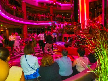 Venice, Italy - June 06, 2015: The people are dancing at Cruise ship Splendour of the Seas by Royal Caribbean International at port Venice, Italy on June 06, 2015. The interior inside the ship clipart