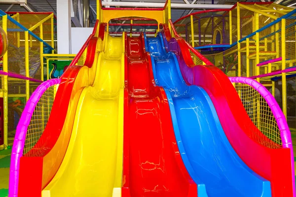 Large childrens playroom with a slide and colorful balls in entertainment center — Stock Photo, Image