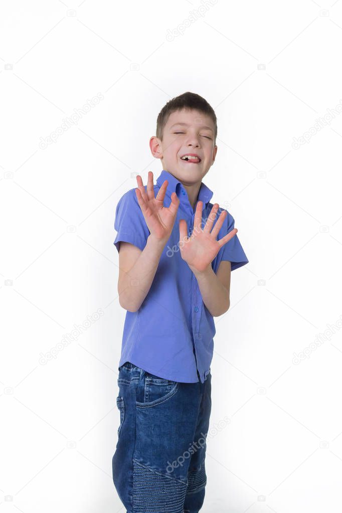 Portrait of a young boy making stop gesture on white background