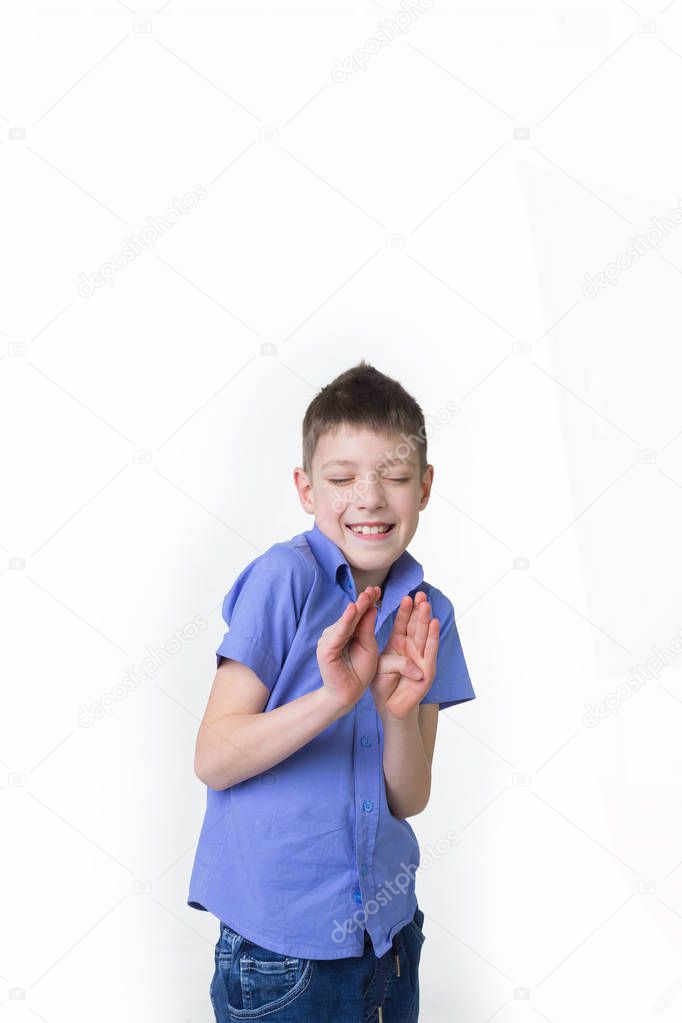 Portrait of a young boy making stop gesture on white background