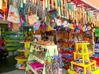 Oranjestad, Aruba - January 8, 2018: The local souvenirs in a street market of Oranjestad. clipart