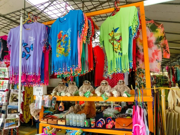 Puerto Limón, Costa Rica - 8 de diciembre de 2019: souvenirs étnicos, gorras de béisbol, bolsos con varios patrones colgando en el mercado callejero — Foto de Stock