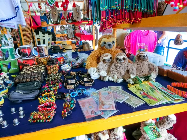 Puerto Limon, Costa Rica - December 8, 2019: Ethnic souvenirs, baseball caps, bags with various pattern hanging in street market — Stock Photo, Image