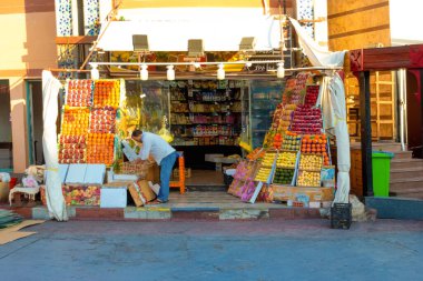 Sharm El Sheikh, Egypt - February 17, 2020: The appetizing showcase of the fruit store with many boxes of mango, oranges, pomegranates, lemons