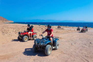 Sharm El Sheikh, Egypt - February 17, 2020: The people at quad tour in the desert in Egypt on vacation panorama