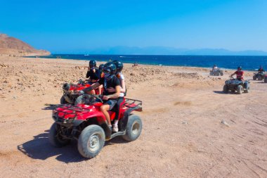 Sharm El Sheikh, Egypt - February 17, 2020: The people at quad tour in the desert in Egypt on vacation panorama