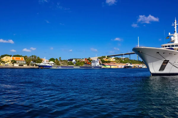 Massive luxury yacht docked near bridge on Curacao at Willemstad