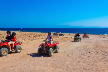Sharm El Sheikh, Egypt - February 17, 2020: The people at quad tour in the desert in Egypt on vacation panorama