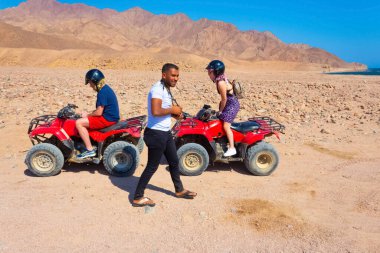 Sharm El Sheikh, Egypt - February 17, 2020: The people at quad tour in the desert in Egypt on vacation panorama