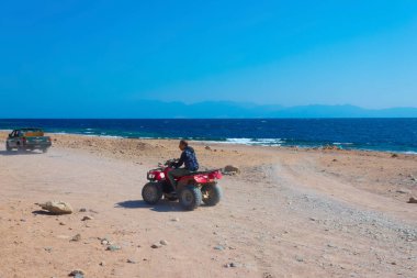 Sharm El Sheikh, Egypt - February 17, 2020: The people at quad tour in the desert in Egypt on vacation panorama