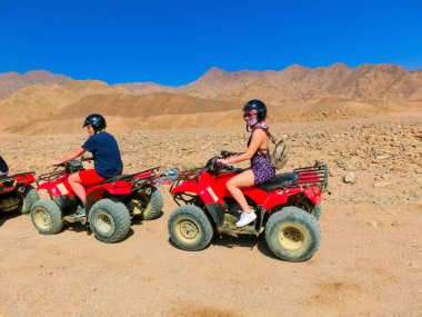 Sharm El Sheikh, Egypt - February 17, 2020: The people at quad tour in the desert in Egypt on vacation panorama