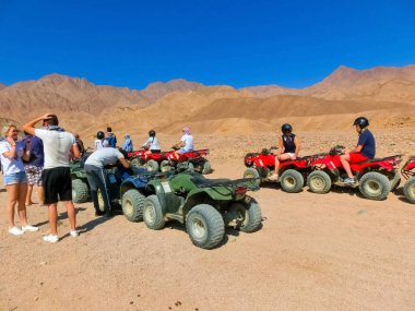 Sharm El Sheikh, Egypt - February 17, 2020: The people at quad tour in the desert in Egypt on vacation panorama