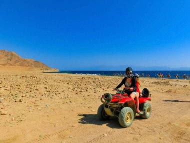 Sharm El Sheikh, Egypt - February 17, 2020: The people at quad tour in the desert in Egypt on vacation panorama