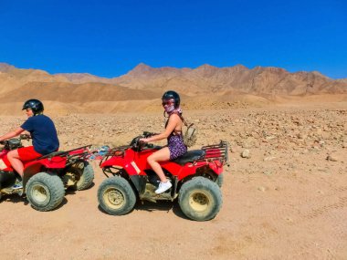 Sharm El Sheikh, Egypt - February 17, 2020: The people at quad tour in the desert in Egypt on vacation panorama