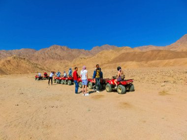 Sharm El Sheikh, Egypt - February 17, 2020: The people at quad tour in the desert in Egypt on vacation panorama