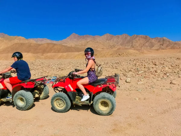 Sharm El Sheikh, Egypt - February 17, 2020: The people at quad tour in the desert in Egypt on vacation panorama