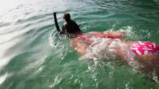 Tonåring flicka snorkling med mask och flippers i blått hav — Stockvideo