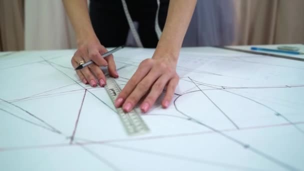 Creative designer drawing clothes pattern on paper in atelier — Stock Video